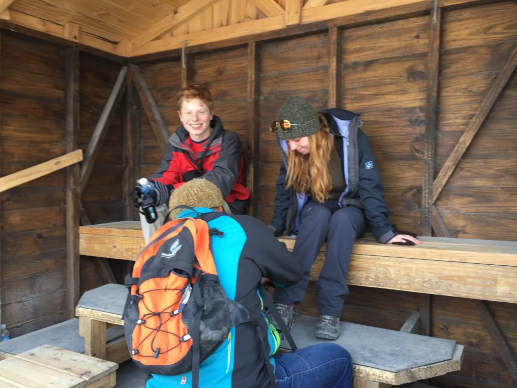 Putting on crampons in shelter. Copyright©2015 reserved to photographer. Contact mapandfamily.com