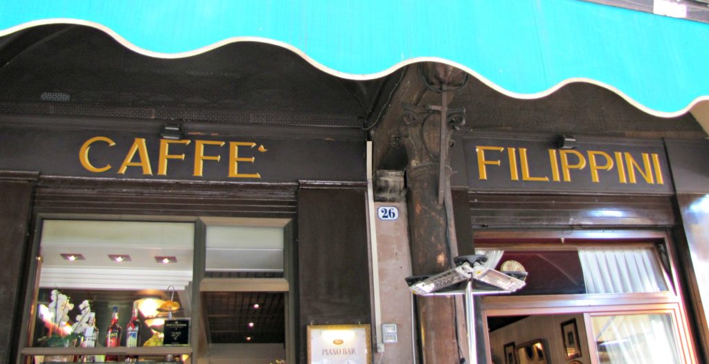 Venice with teens: Turquoise awning outside Caffe Filippini in Piazza Erbe, Verona. Copyright©2015 mapandfamily.com