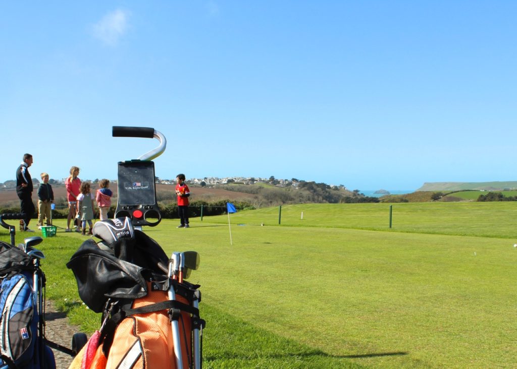 Things to do in Polzeath Cornwall: juniors on putting green of the golf course at The Point at Polzeath