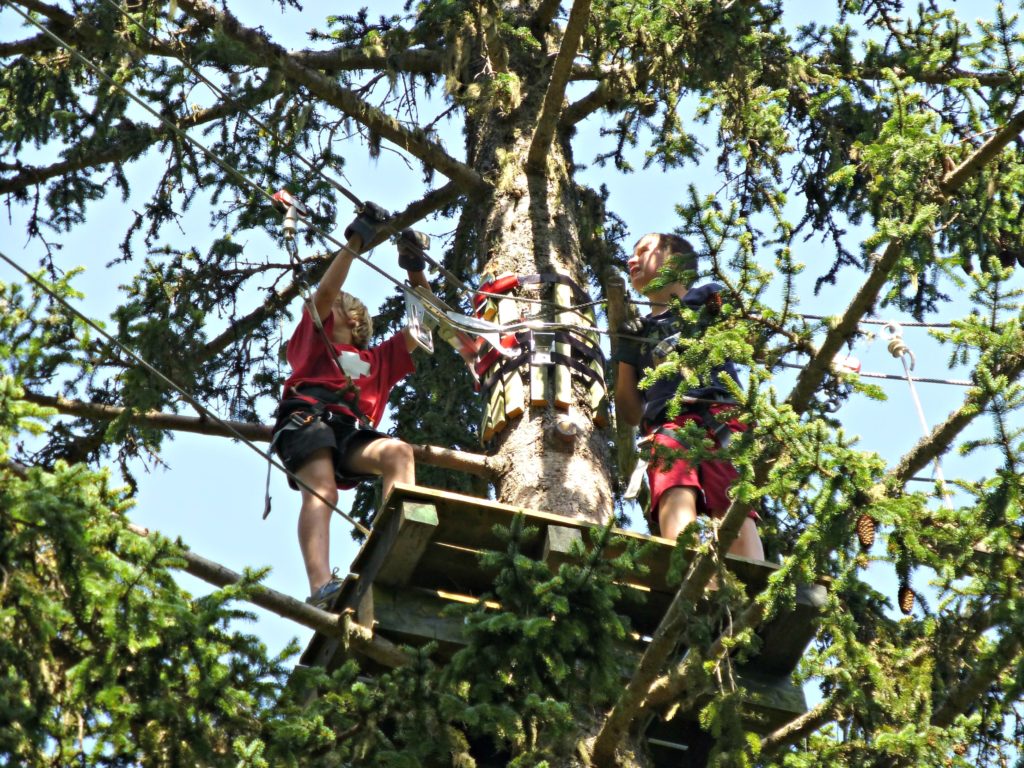 Family camping Swiss Alps zipline in trees. Copyright©2015 reserved to photographer. Contact mapandfamily.com