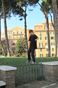 Rome with teens: boy on fence. Copyright©2016 reserved to photographer via mapandfamily.com