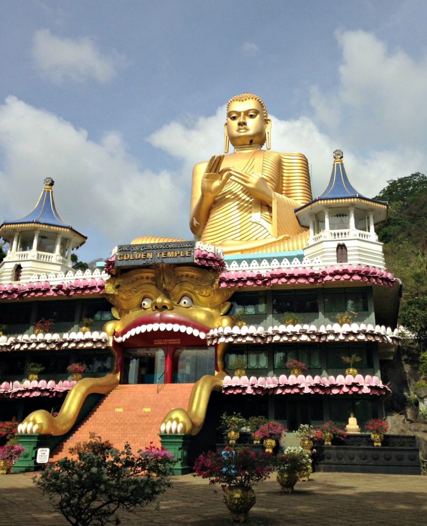 Places to Visit in Sri Lanka on a family trip. Golden Buddha at entrance to Dambulla cave temple. Copyright©2017 reserved to photographer via mapandfamily.com 