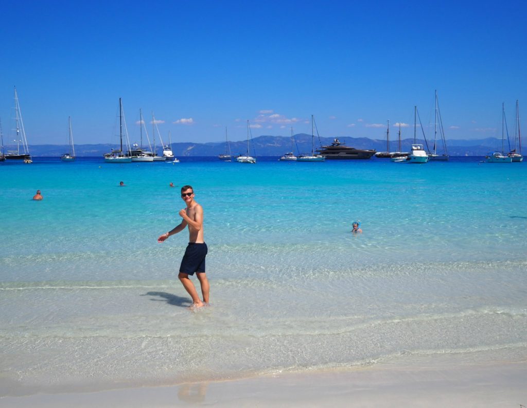 Boy paddling in turquoise sea at Voutoumi beach, Antipaxos Copyright©2017 mapandfamily.com 