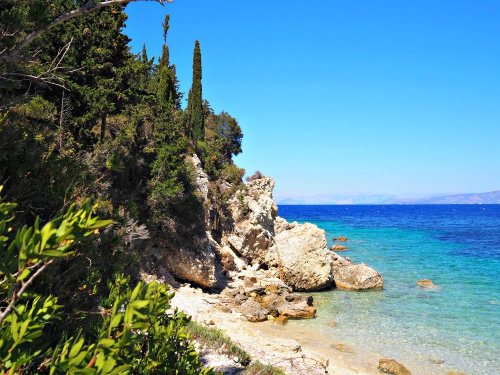 Rocks and trees overlooking Lakkos beach on Paxos. Copyright©2017 mapandfamily.com 