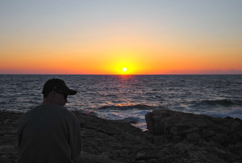 Deep orange sunset as sun touches the horizon on Plani beach Paxos. Copyright©2017 mapandfamily.com 