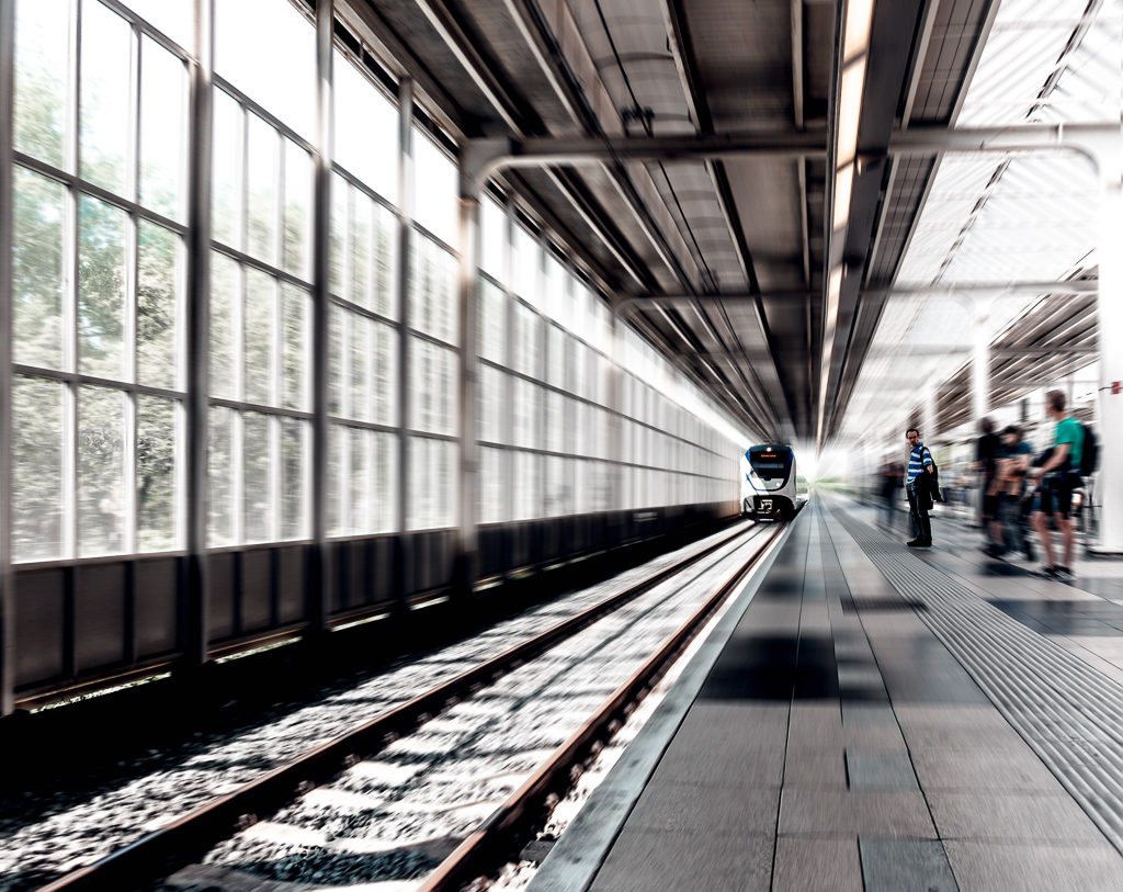 Top interrailing tips for summer trips to Europe by train. Train pulls in to station in Amsterdam