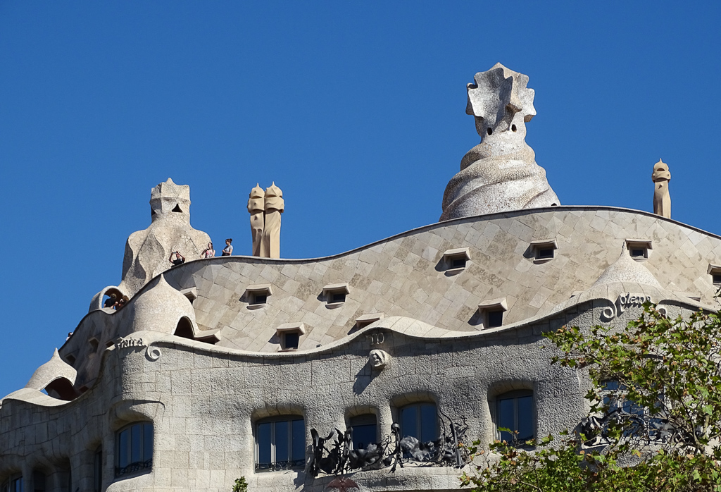 Gaudi buildings Barcelona. The fabulous wavy roof and walls of Casa Mila against a blue sky. Copyright@2019mapandfamily.com