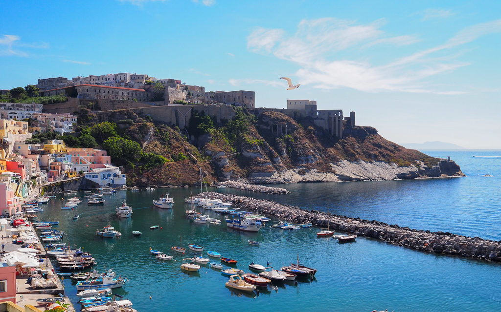 Day trip to Prodica island, Italy. View of Terra Murata on hillside above Corricella harbour. Copyright©2019 mapandfamily.com 