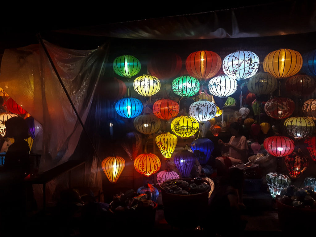 Vietnam highlights: multi coloured lanterns decorating a shop in Hoi An at night. Copyright ©2019 mapandfamily.com 