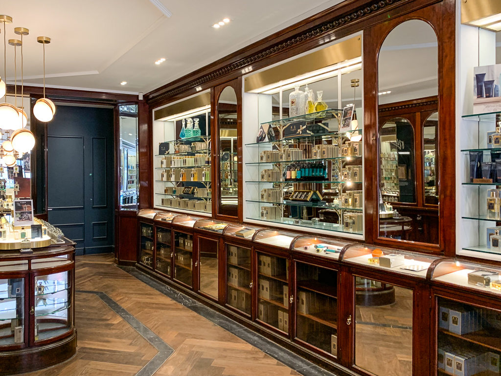 Interior of Floris showing antique wood cabinets containing fragrances. Copyright ©2019 mapandfamily.com