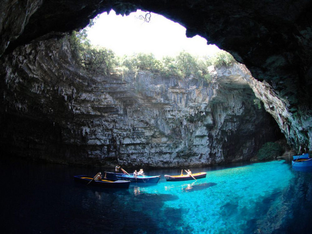 Boats on an underground lake open to the sky. Copyright @2019 reserved to the photographer via mapandfamily.com 