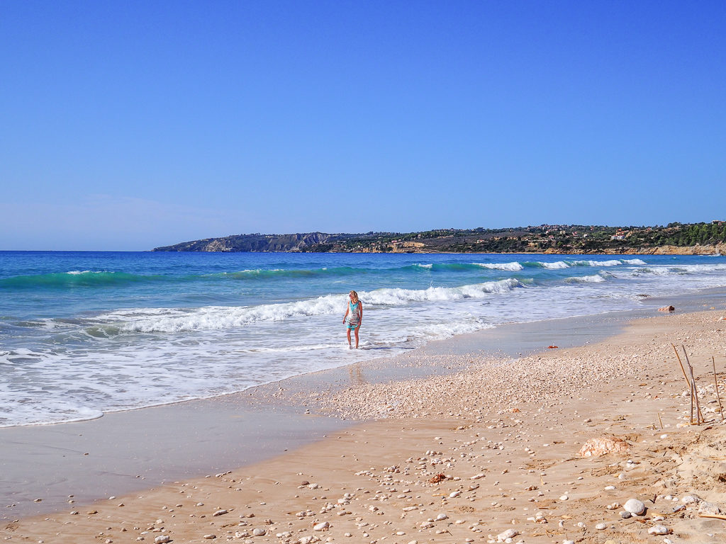 Walking along the water's edge on deserted Kanali beach in the south of Kefalonia. Copyright ©2019 mapandfamily.com 