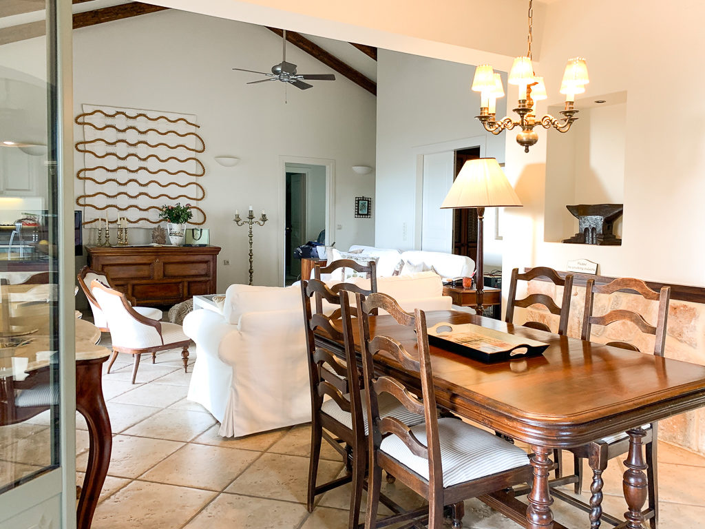 Interior of Kefalonia villa with cook showing the dining area and sitting room. Copyright ©2020 mapandfamily.com 