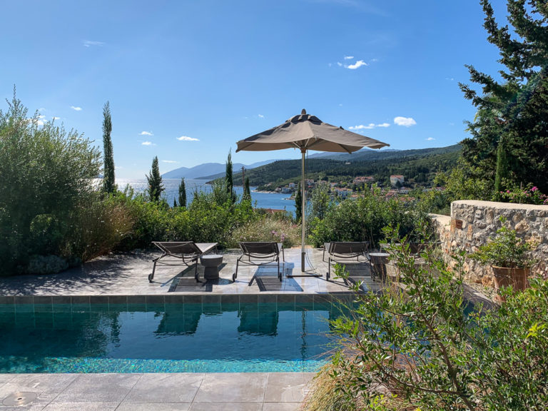 Fiscardo villa, view from terrace of pool, sunloungers and Fiscardo bay. Copyright ©mapandfamily.com