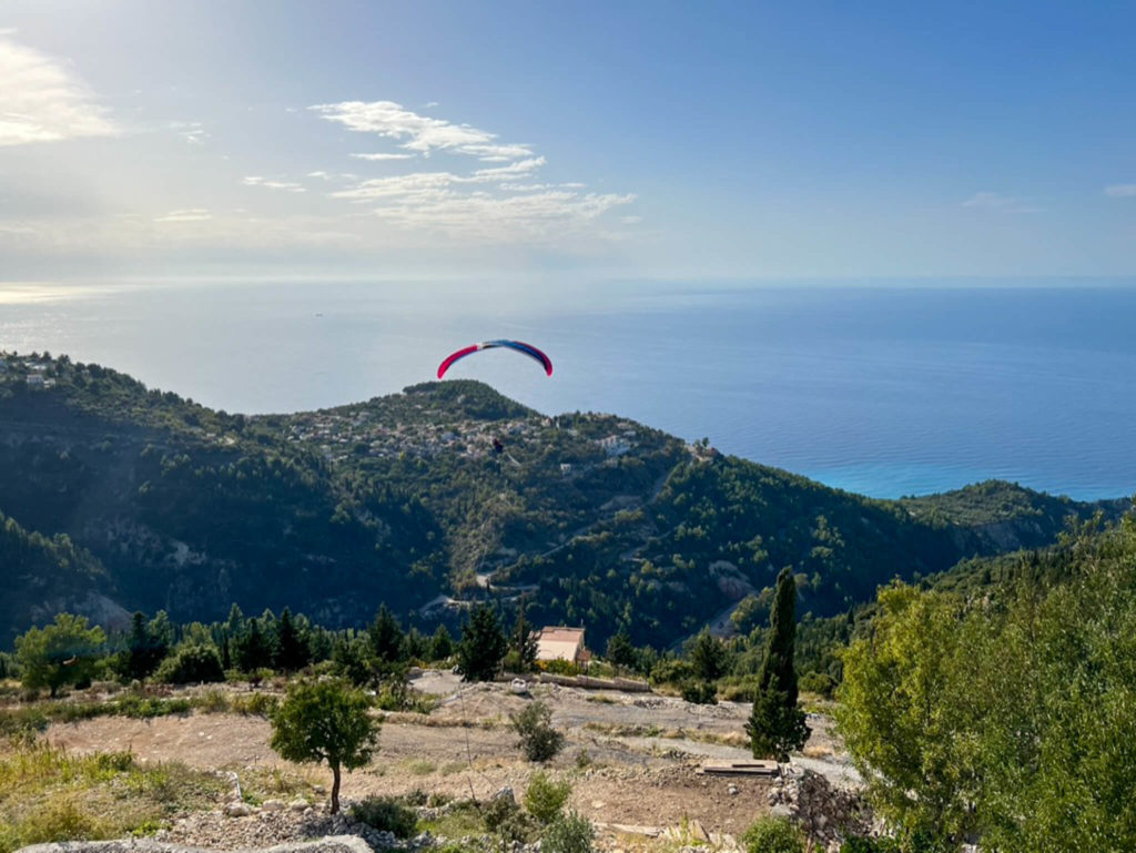 Paragliding down the hillside towards the sea from Rachi in Exanthia, Lefkada. Copyright@ 2022 mapandfamily.com 