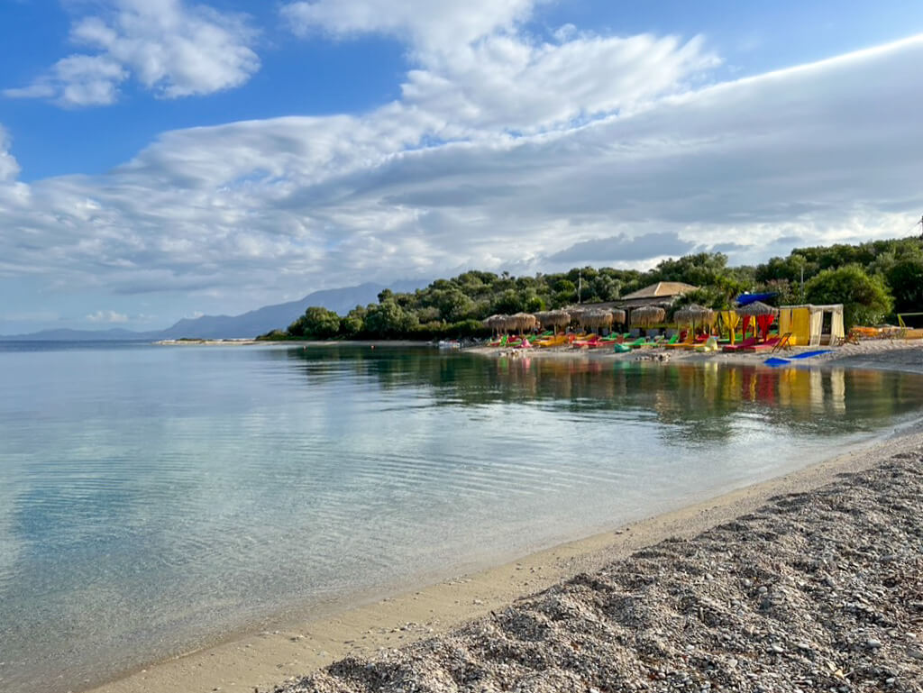 Colourful sun beds and straw parasols on Fanari beach, Meganisi. Copyright@ 2022 mapandfamily.com