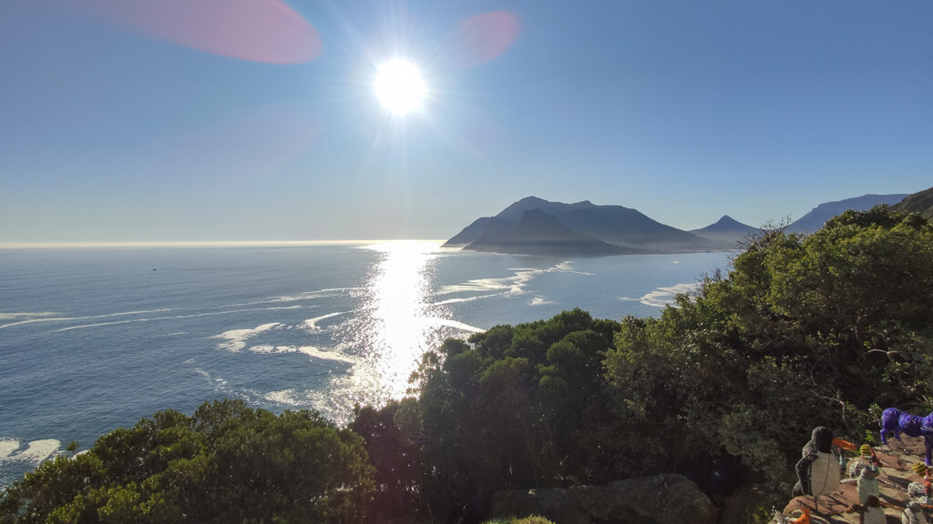 View of sun on wide bay with mountains in background. Copyright @2023 reserved to photographer via mapandfamily.com 