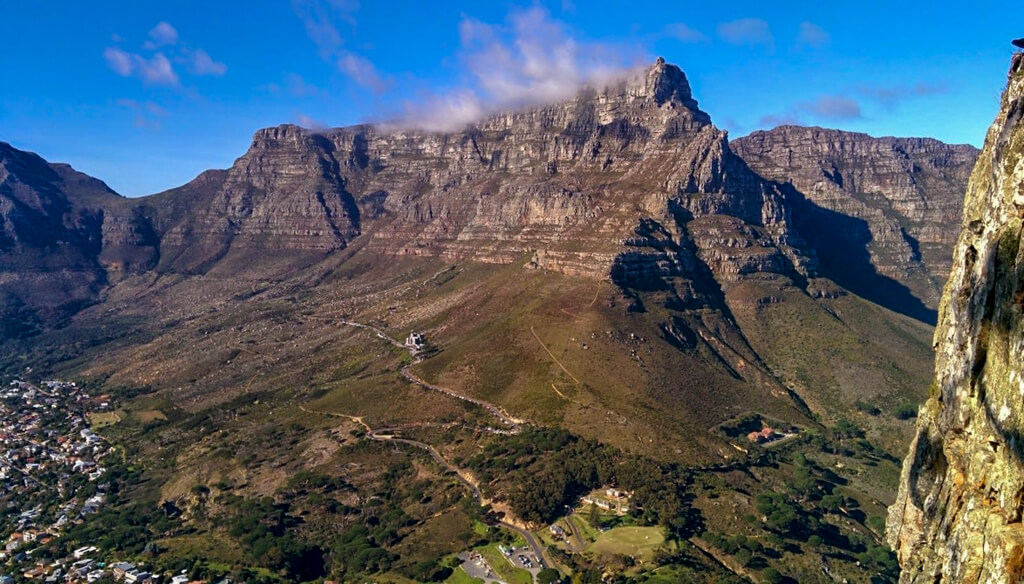 View of cable car in distance on side of Table Mountain Copyright@2023 reserved to photographer via mapandfamily.com 