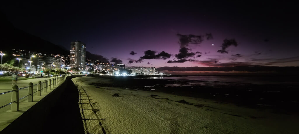 Purple sky over the sea with street lights along a promenade. Copyright@2023 reserved to photographer via mapandfamily.com