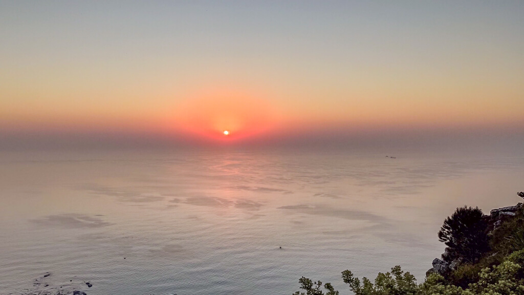 Sun setting into ocean viewed from top of Table Mountain. Copyright@2024 reserved to photographer via mapandfamily.com 