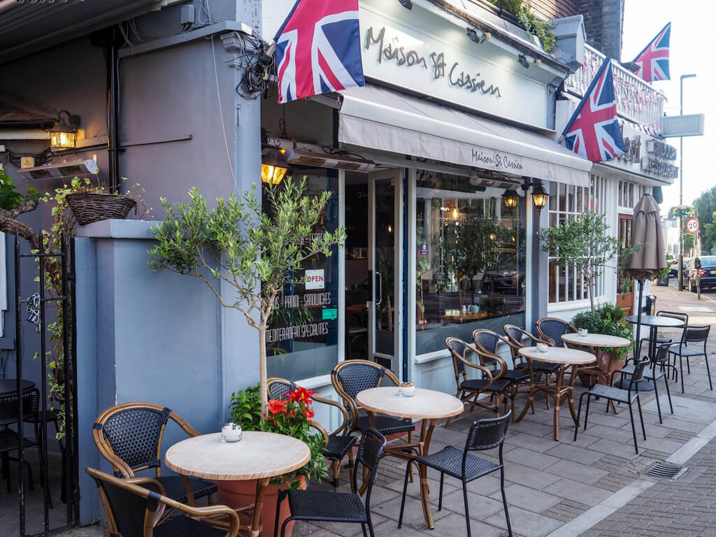 One of the best cafes in Wimbledon. Outdoor cafe tables and chairs in front of cafe, Maison St Cassien. Copyright@2023 mapandfamily.com 