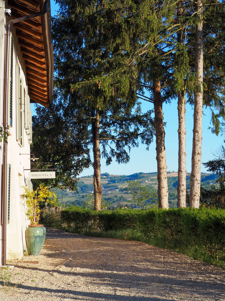 Gallery of 2 photos showing a pathway that. runs alongside the farmhouses at Villa Giara. Copyright@2023mapandfamily.com