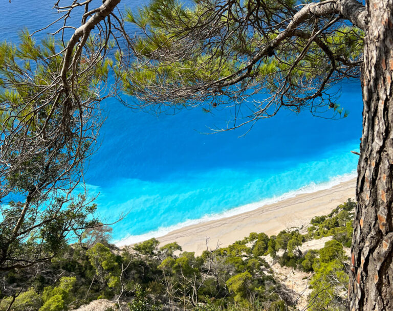 View of the turquoise sea and pale sand on south west coast beaches on Lefkada. Copyright@2023mapandfamily.com