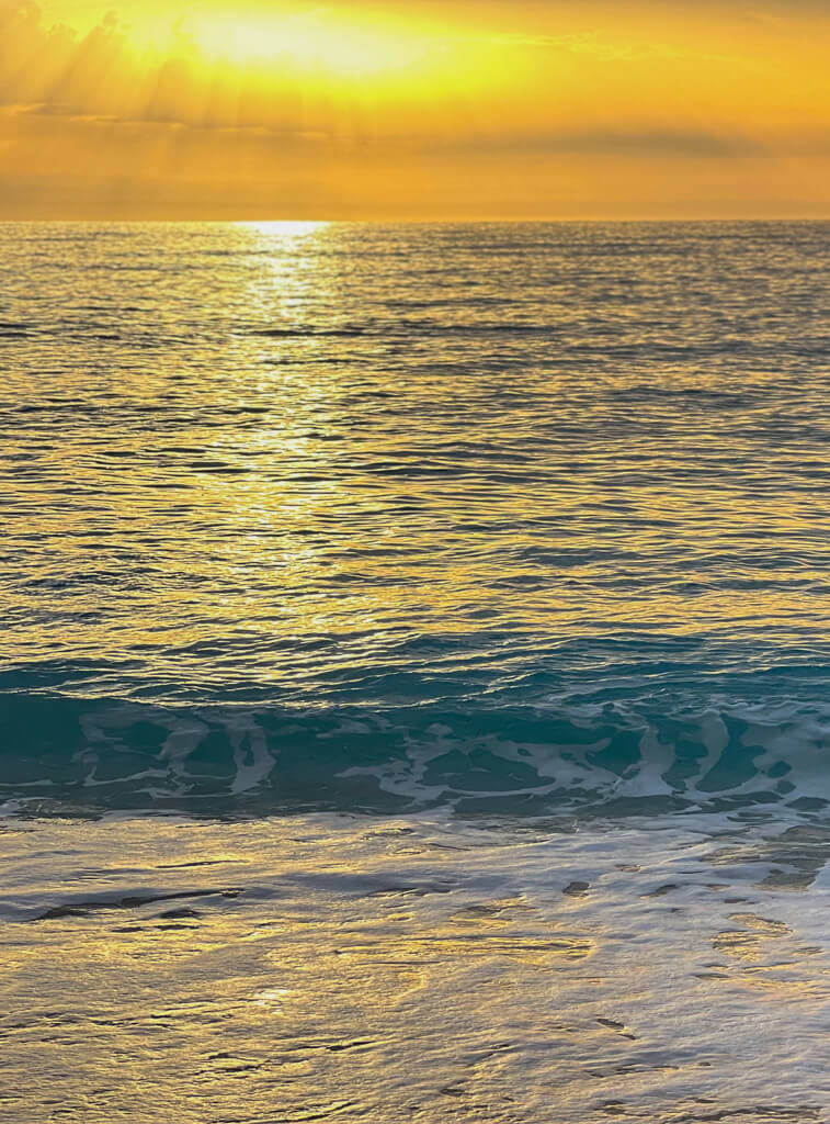 A golden sunset on the water at Kathisma Beach Lefkada. Copyright@2023mapandfamily.com 