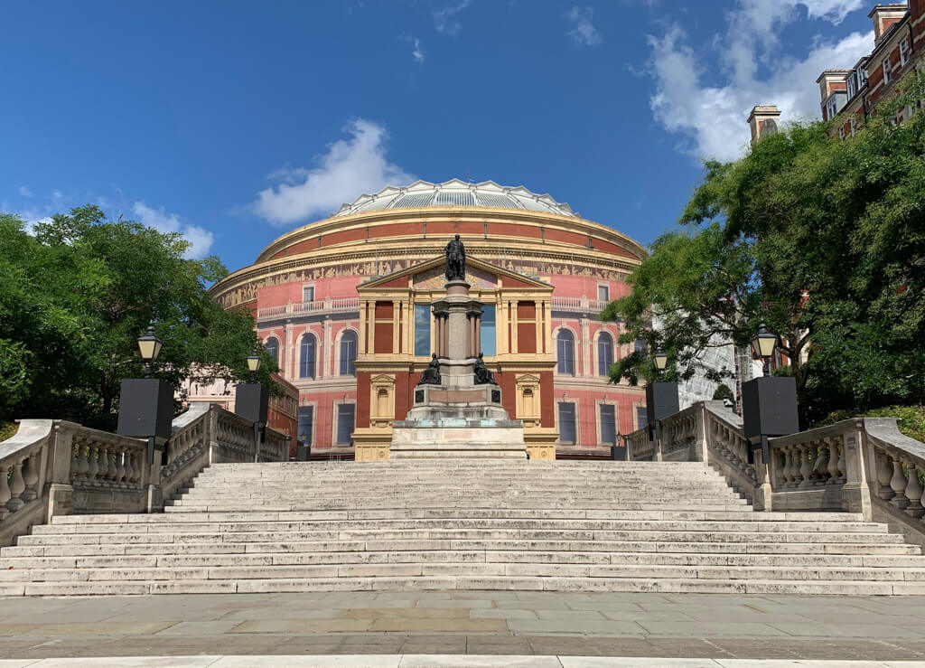 The striking oval red brick Royal Albert Hall has a glass domed roof. Copyright@2023 mapandfamily.com