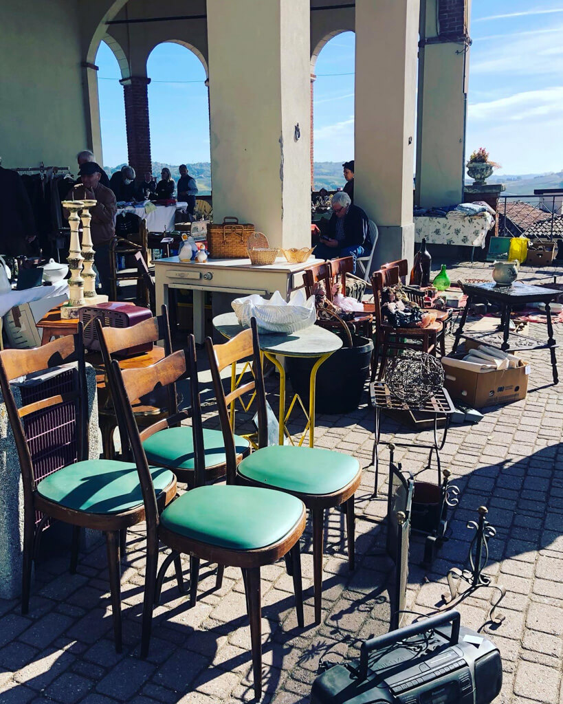 Chairs and tables at outdoor flea market in colonnade. Copyright@2023 reserved to the photographer via mapandfamily.com