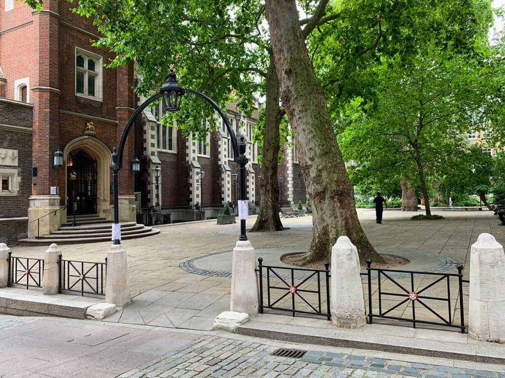 Peaceful paved square with trees and historic buildings in London. Copyright@2023mapandfamily.com 