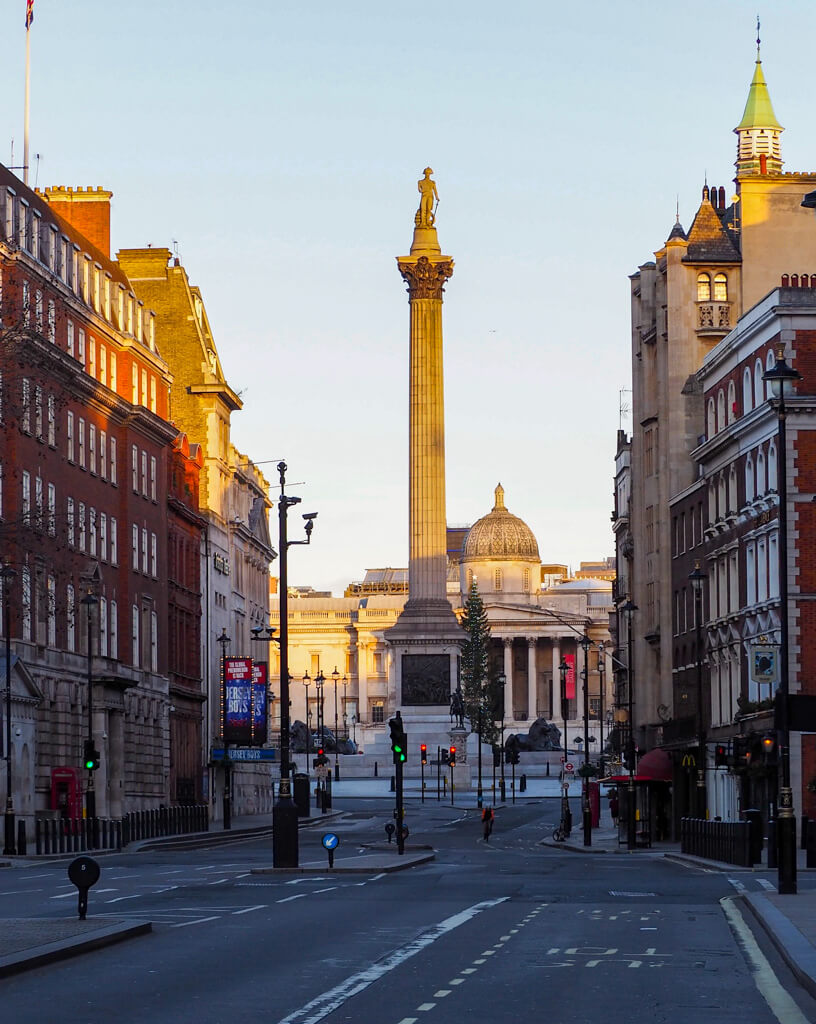 Nelson's Column early on Christmas morning against a pale sky in a very quiet Trafalgar Square. Copyright @2023 mapandfamily.com 