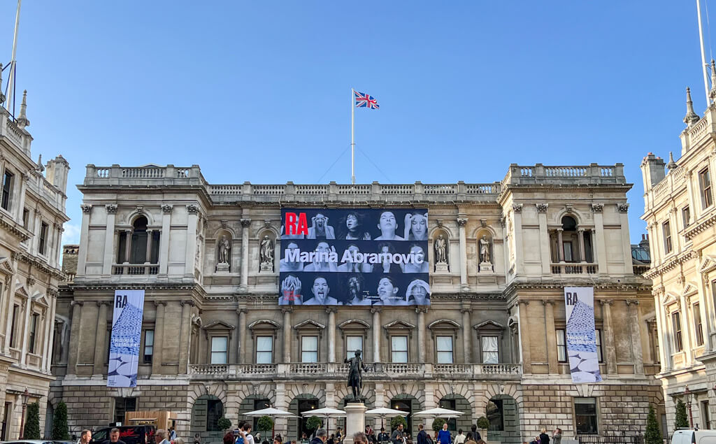 Exterior of Royal Academy against blue sky, looking into the courtyard. Copyright@2023 mapandfamily.com