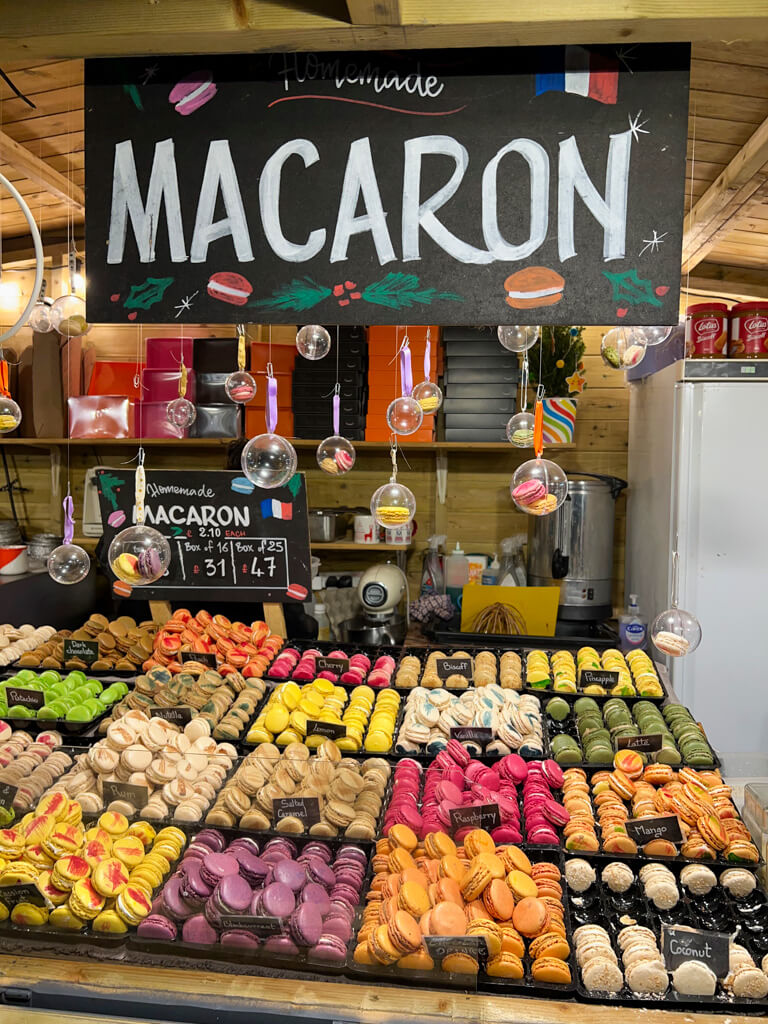 Brightly coloured macarons on food stall. Copyright@2023 mapanfamily.com 