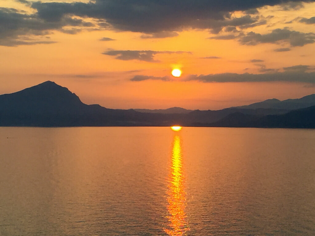 A glorious orange and apricot sunset on the coast road of Maratea Italy Copyright@2024 reserved to the photographer via mapandfamily.com 