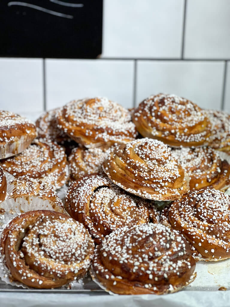 Heap of sugared buns with white tile behind. Copyright@2024mapandfamily.com 