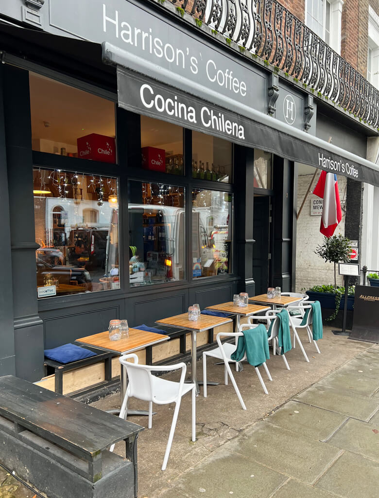 Cafes in Paddington: exterior of Harrison's Coffee with an awning over a row of outdoor tables and chairs. Copyright@2024 mapandfamily.com