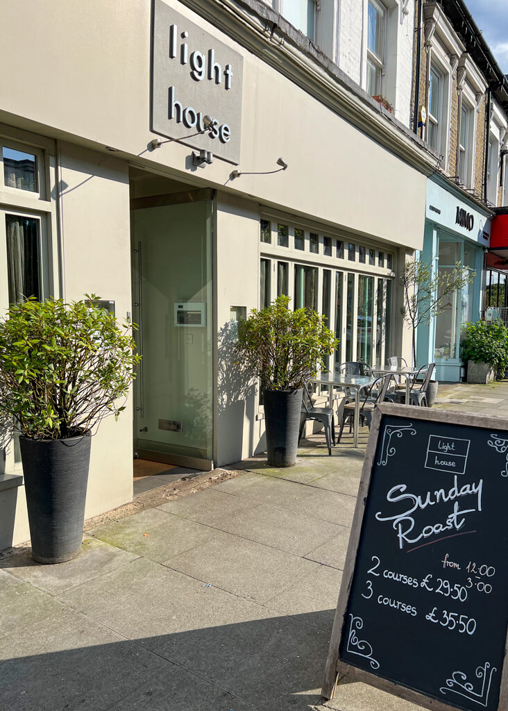 Exterior of Light House restaurant in Wimbledon Village with a blackboard on pavement listing Sunday roast. Copyright@2024 Nancy Roberts